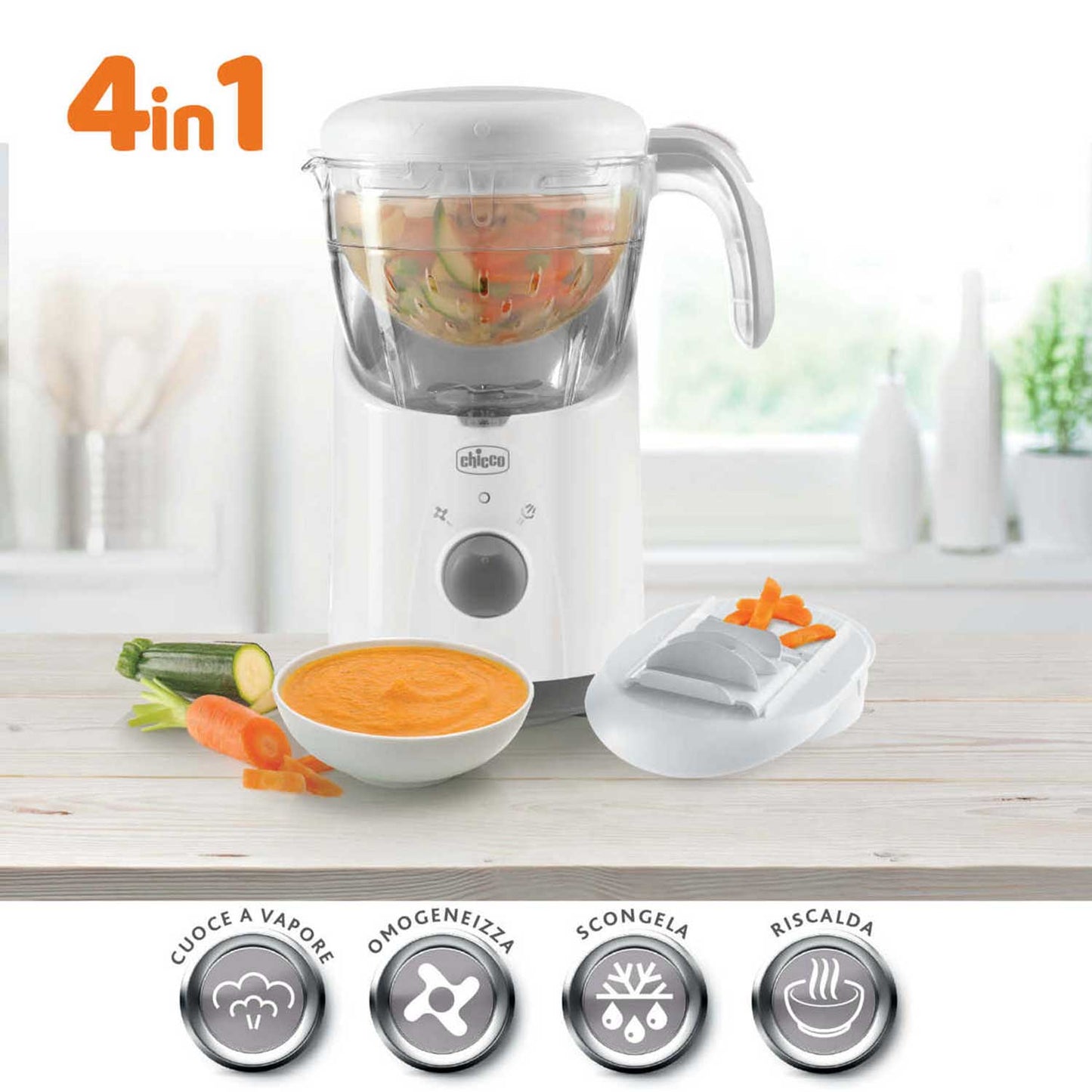 Chicco 4-in-1 baby food maker steams vegetables in its glass container. The appliance sits on a countertop beside fresh zucchini, carrots, and a bowl of homemade baby food.