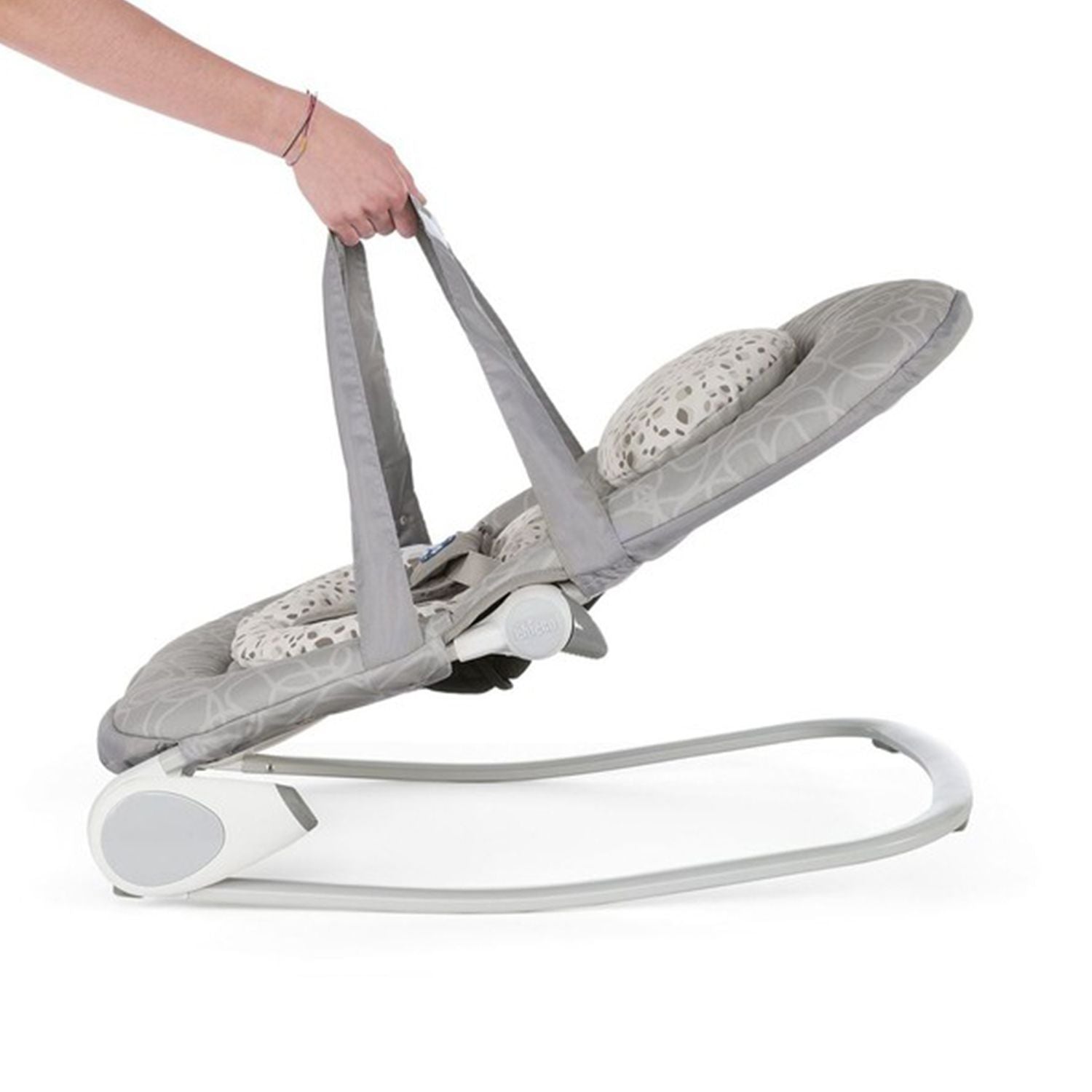 Woman lifts gray and white adjustable baby rocker with one hand, showcasing its portability.