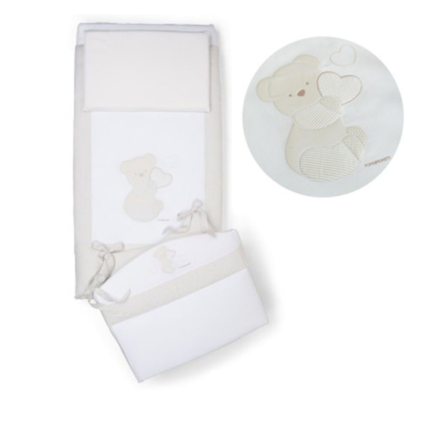 Cream-colored baby crib bedding set featuring embroidered teddy bear holding a heart.