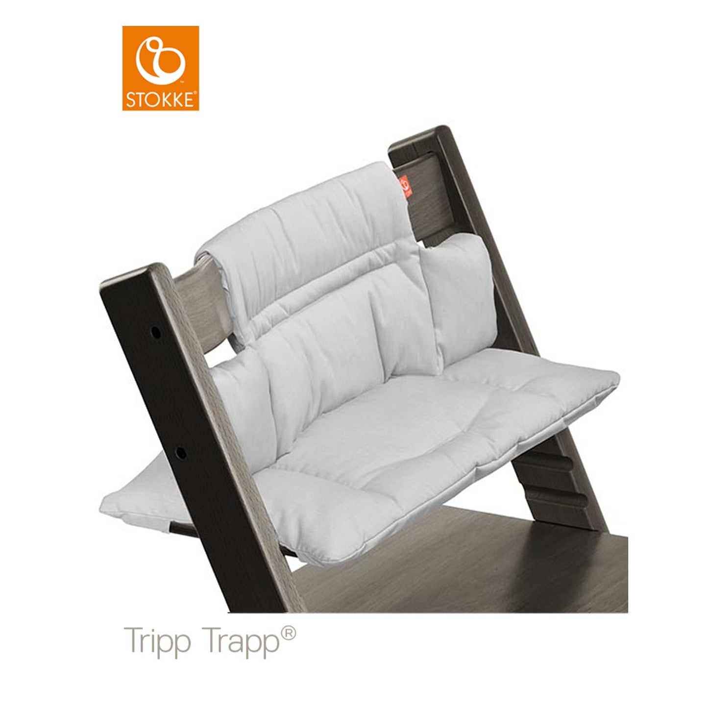 White Stokke Tripp Trapp high chair cushion secures to chair with white stitching and provides comfortable support.