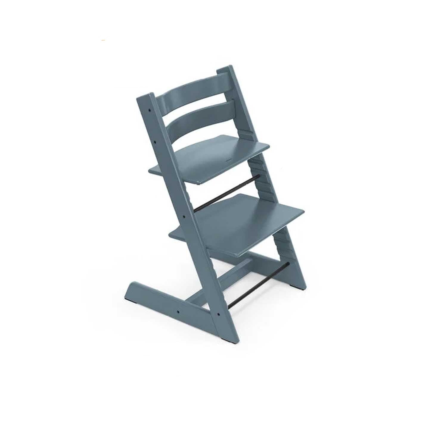 A slate blue adjustable wooden high chair sits at an angle, ready for mealtime.