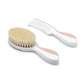 White and pink baby brush and comb set with soft, natural bristles for gentle grooming. 
