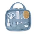 Open blue baby grooming kit displays soft-bristled brush, comb, scissors, nail clippers, and other tools for infant care. 
