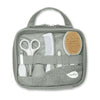 Gray Nuvita baby grooming kit displays comb, brush, scissors, and clippers through mesh front pocket. 
