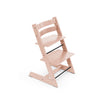 Pink adjustable wooden high chair with black footrest. 
