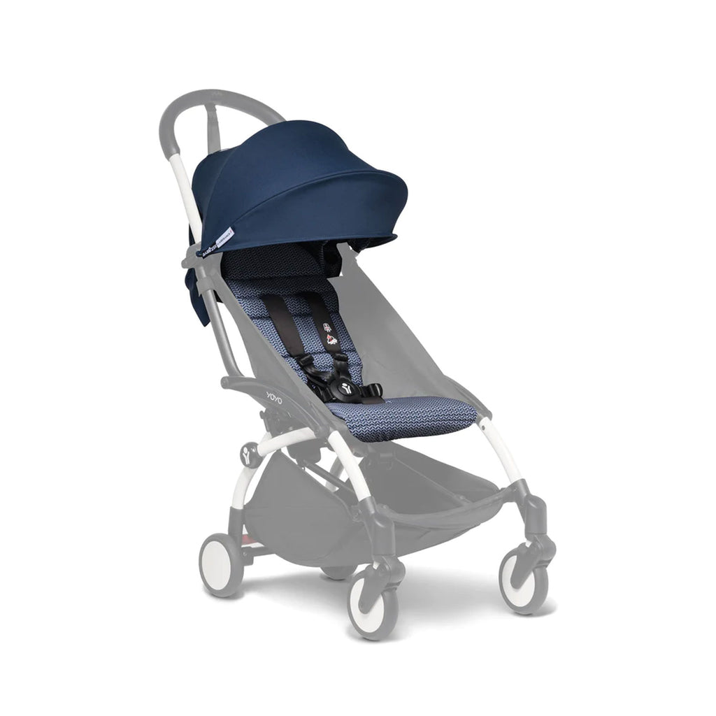 Navy blue stroller sunshade shields a geometric-patterned stroller seat. 
