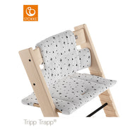 Stokke Tripp Trapp high chair featuring a white and black geometric patterned seat cushion and back support. 
