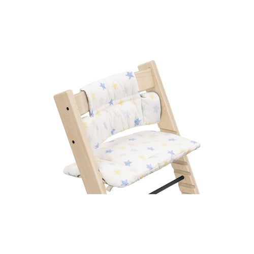 Wooden high chair featuring a removable cushion with a colorful star pattern. 
