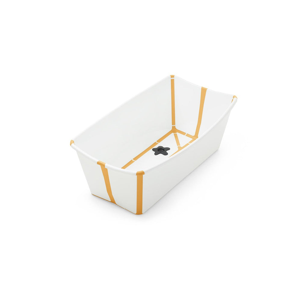White baby bathtub with mustard yellow stripes and a black drain plug. 
