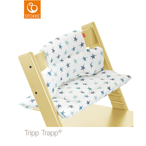 Stokke Tripp Trapp high chair fitted with a white and blue star-patterned baby cushion set. 
