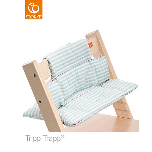 Stokke Tripp Trapp high chair fitted with a light blue and white striped cushion set. 
