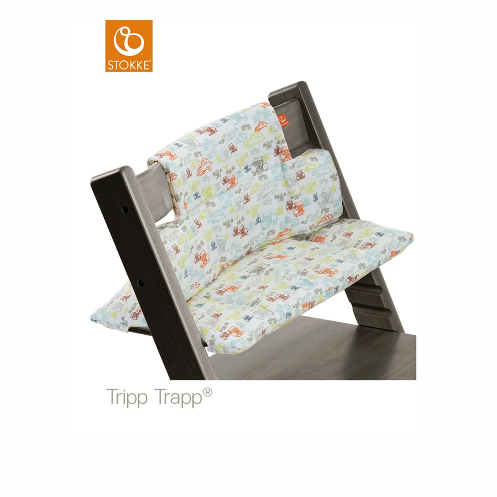 Stokke Tripp Trapp high chair featuring a playful car-themed cushion set in grey. 
