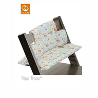 Stokke Tripp Trapp high chair featuring a playful car-themed cushion set in grey. 
